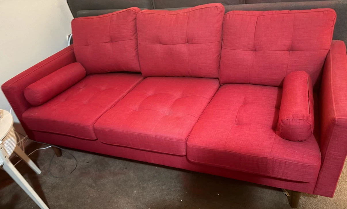 Red Tufted Sofa with Bolster Pillows