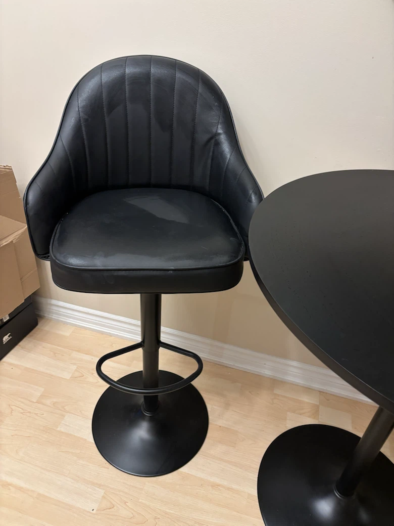 Two black high stools and table