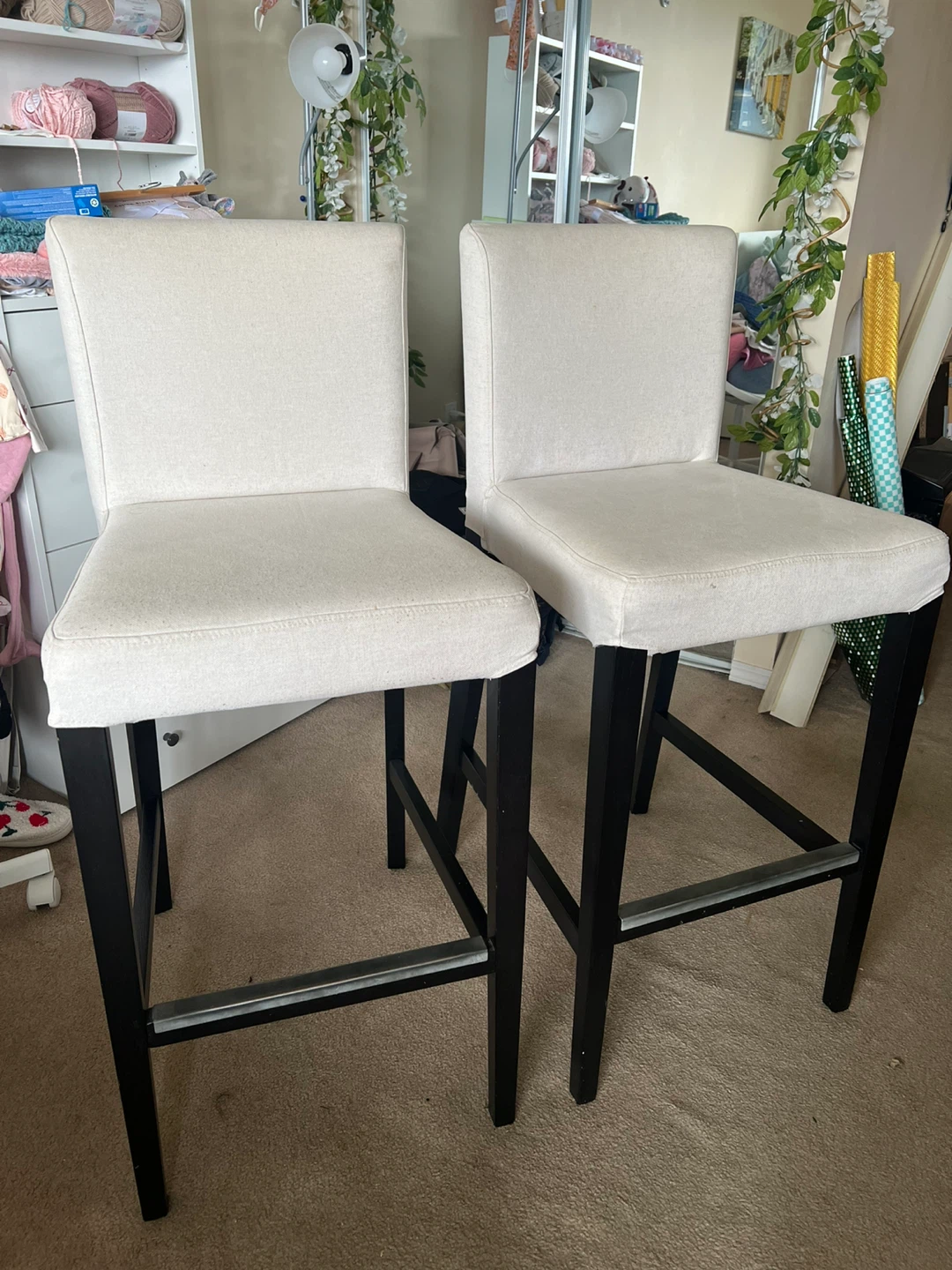 Two wooden barstools, cushioned with back rest