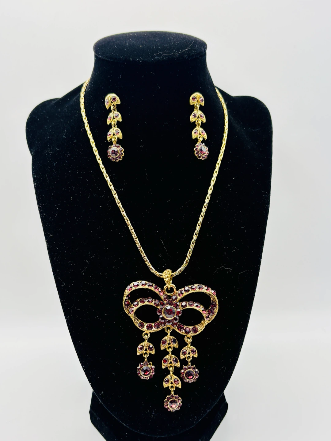 Gold-tone necklace and earring set with purple rhinestones
