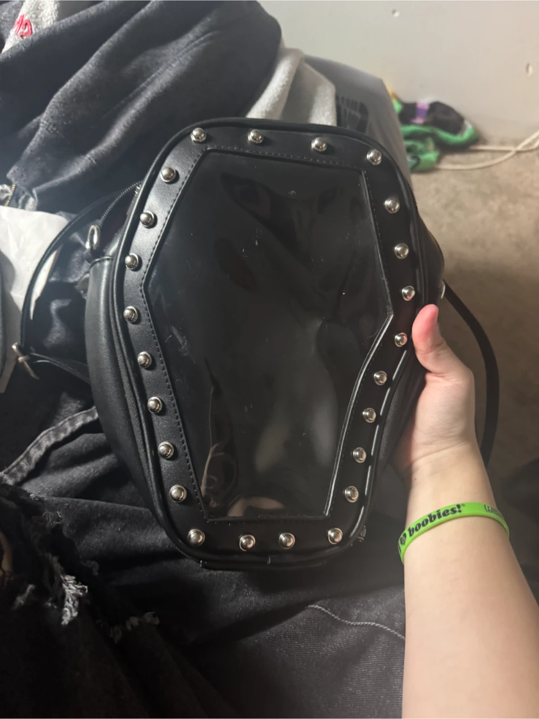 Coffin shaped backpack with an assortment of enamel pins!