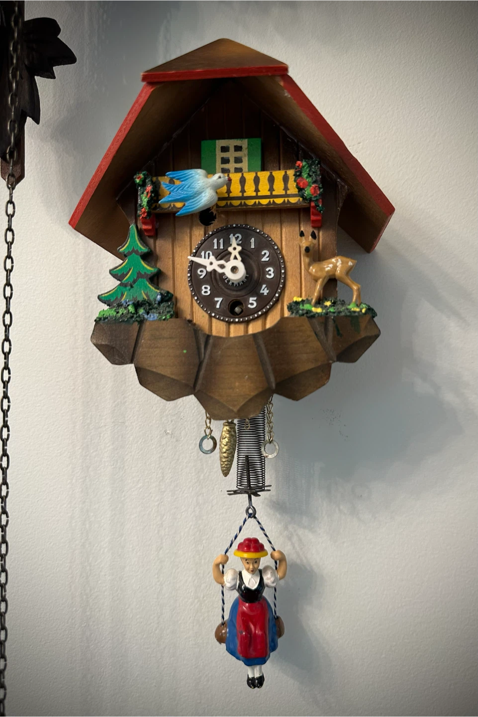 German chalet style Cuckoo Clock with bouncing girl on a swing