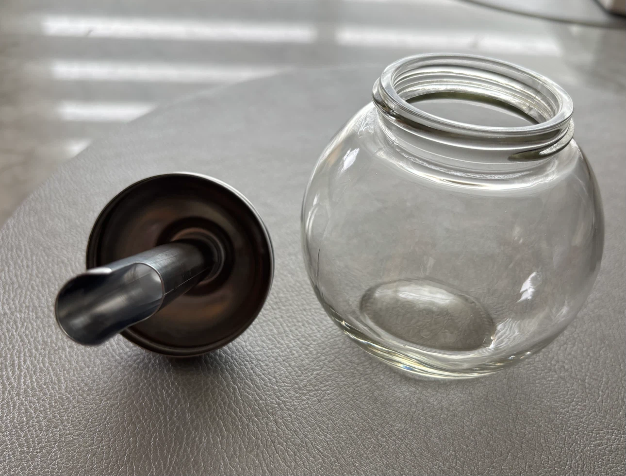 Glass sugar dispenser with metal lid