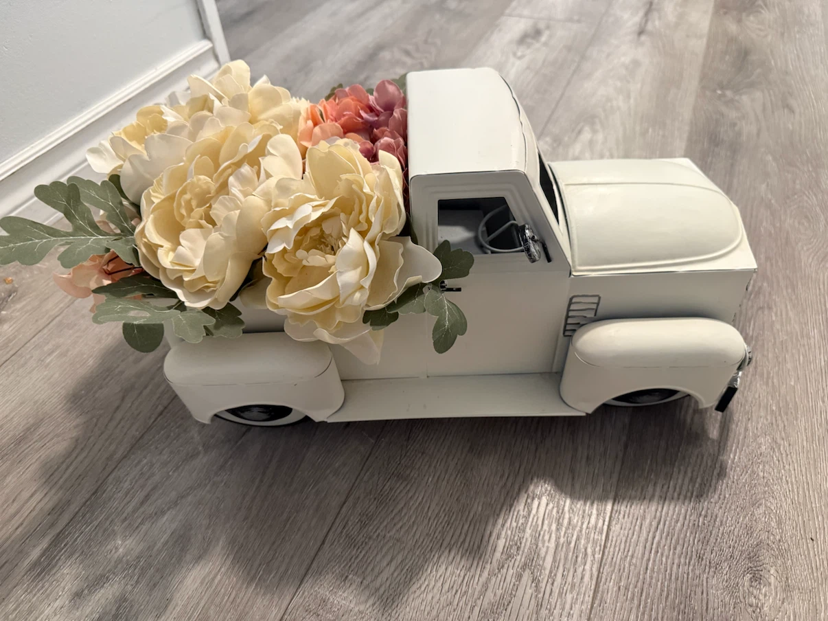 White metal pickup truck decorative accent with faux flowers