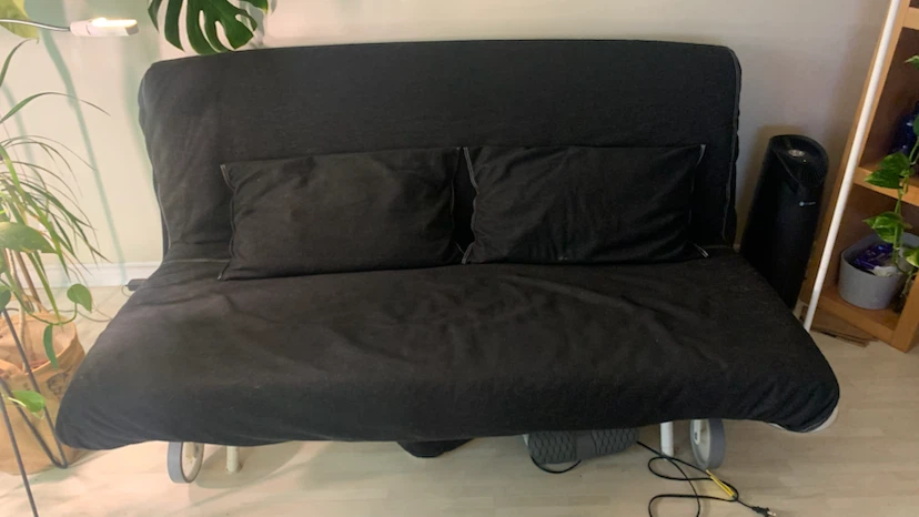 Black Futon Sofa with Two Pillows
