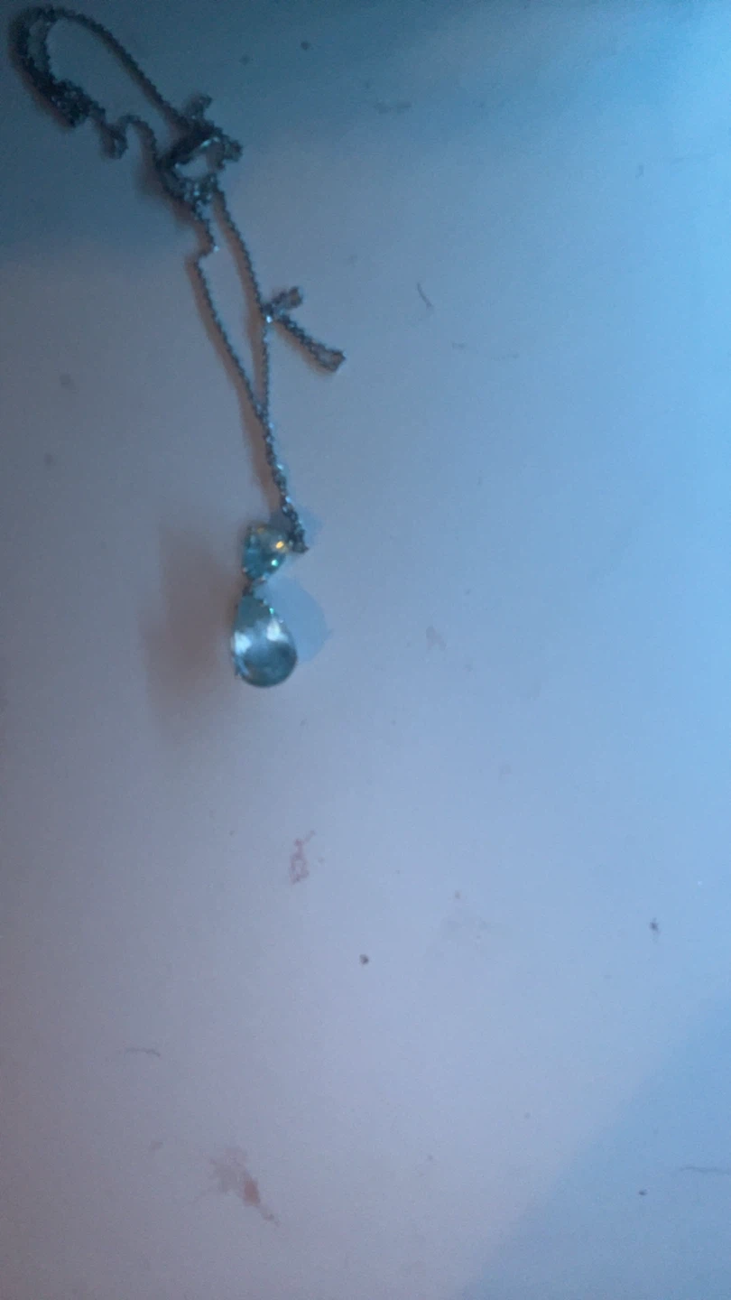 Silver-tone pendant necklace with light blue teardrop gem