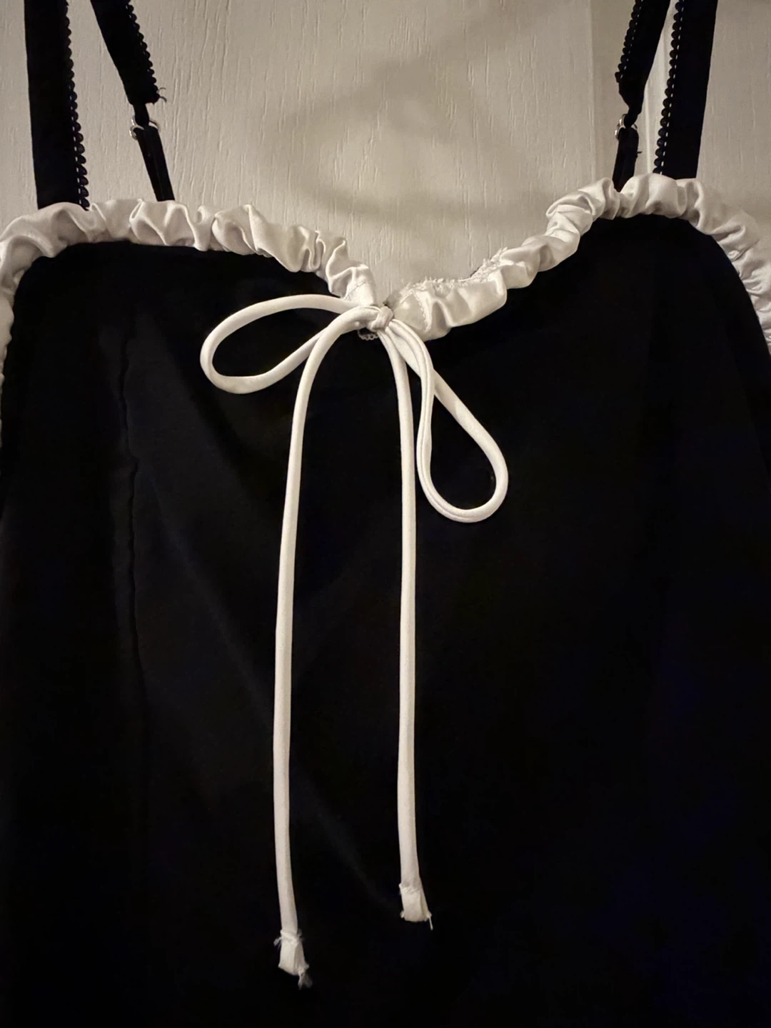 Black dress with adjustable straps and a white ruffle trim - photo 2
