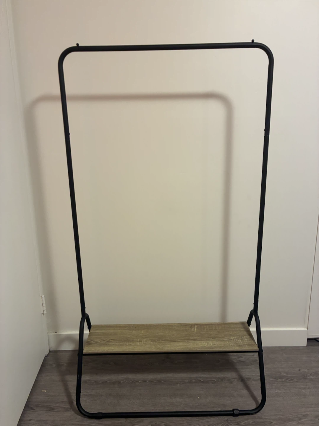 Black garment rack with wood shelf