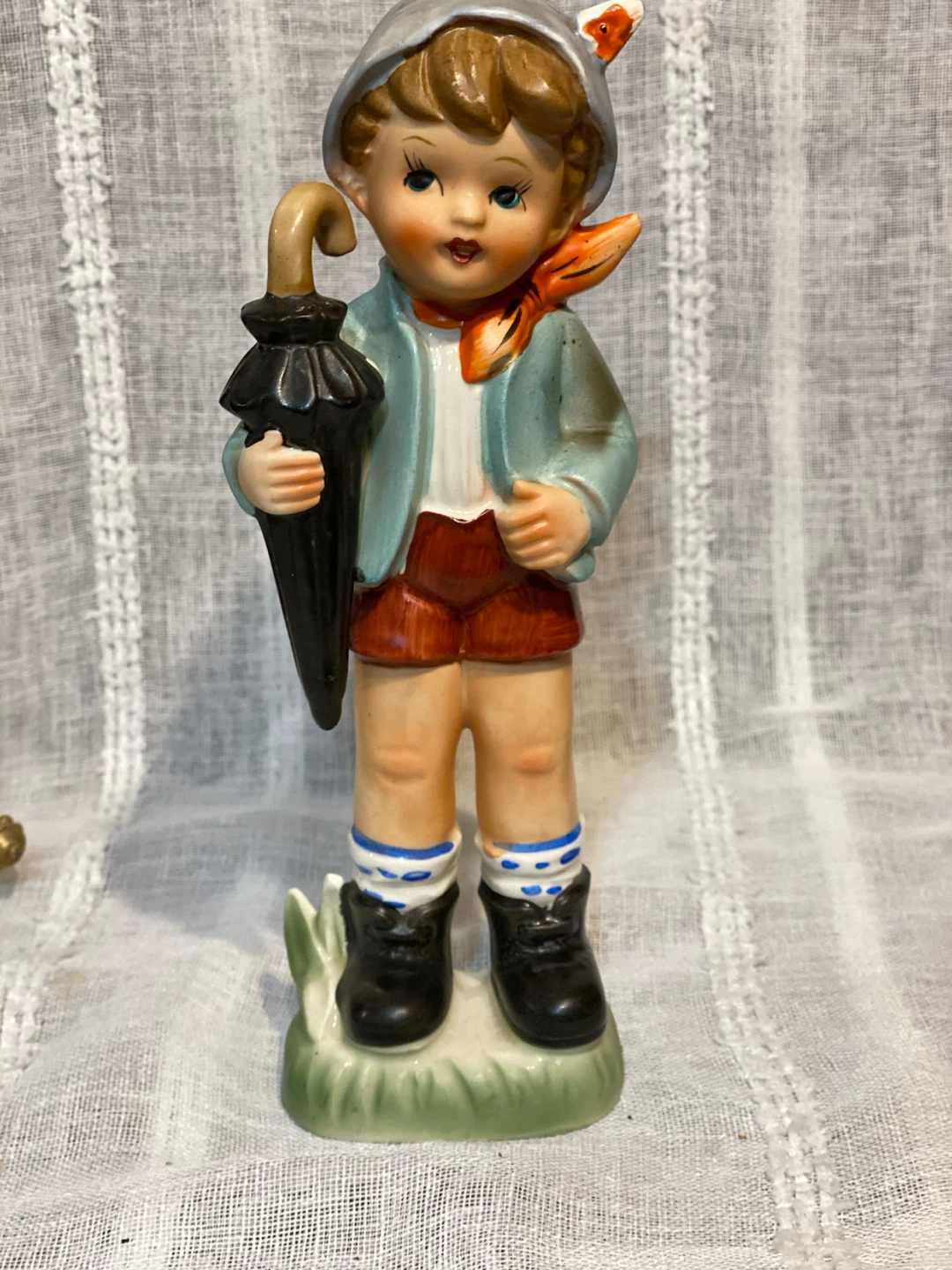 Vintage Ceramic Figurine of a Boy with Umbrella