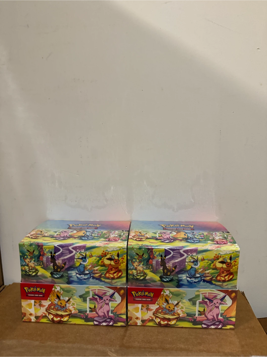 Prismatic evolutions mini tin display