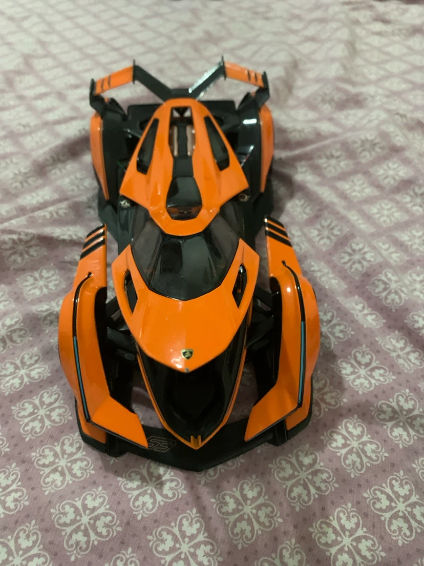 Orange and Black toy Car the seat of the car is kinda lose