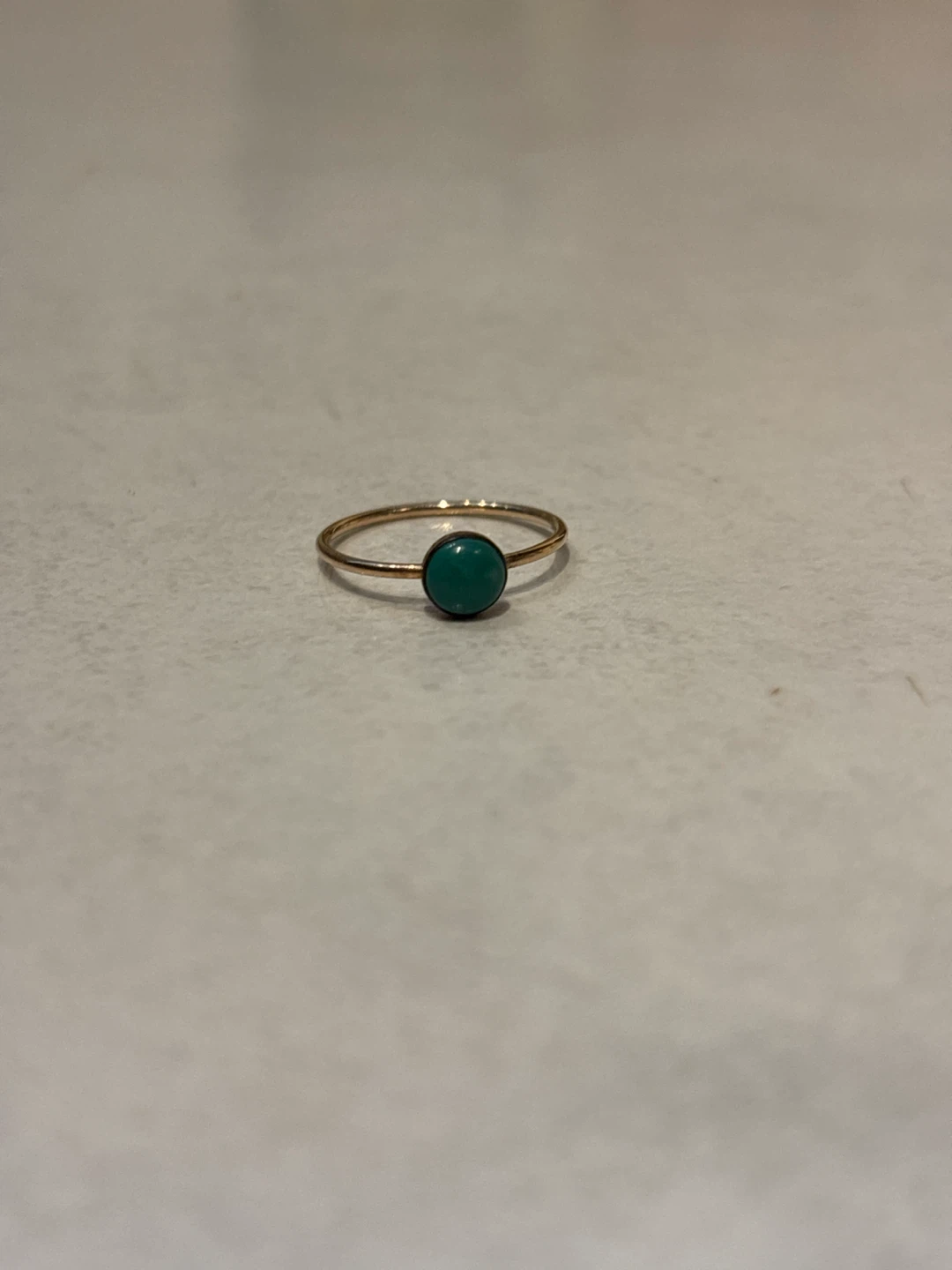 Gold-tone ring with green stone