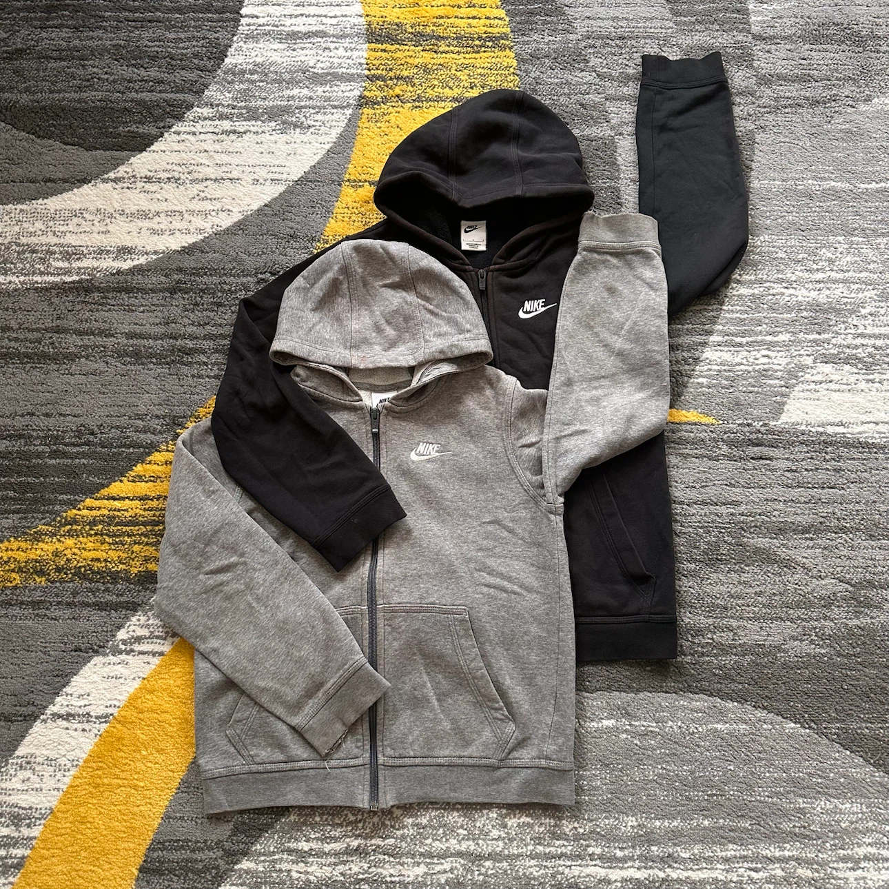 Black and grey Nike zip up hoodies