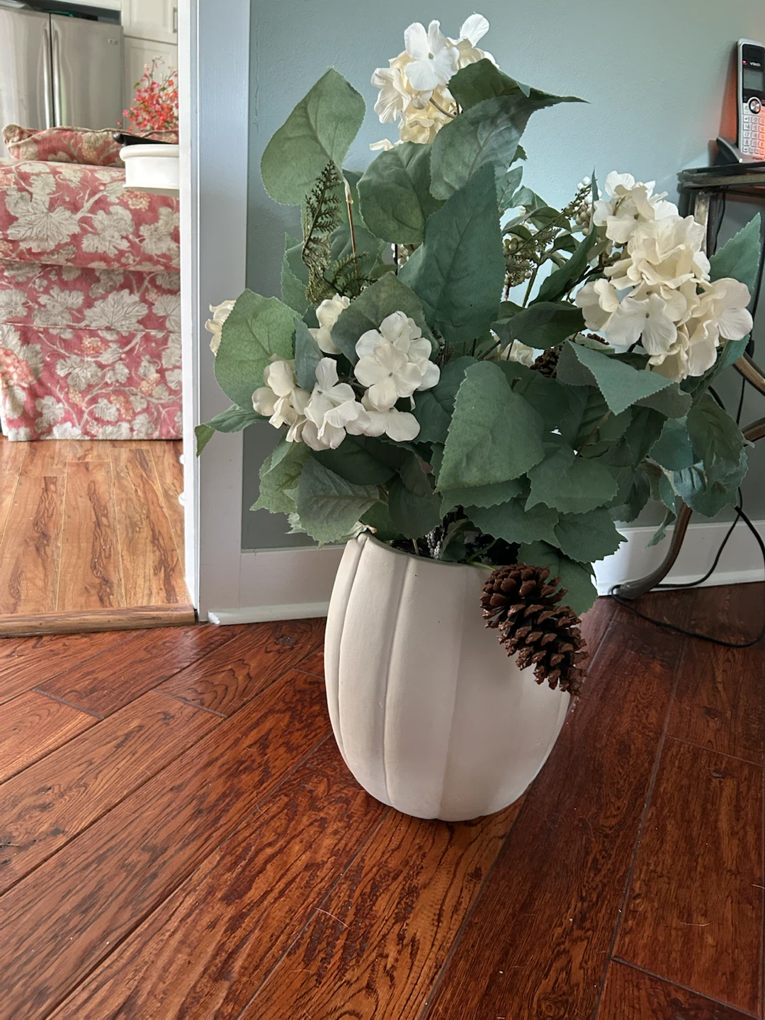 Floral arrangement in cream vase