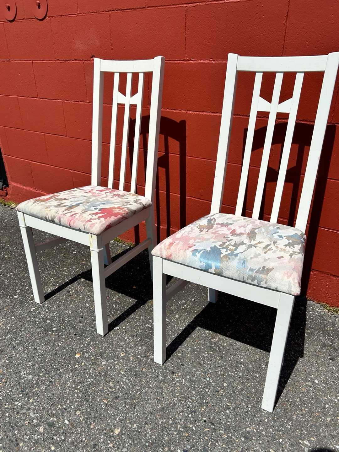 Pair of white dining chairs with floral pattern seats