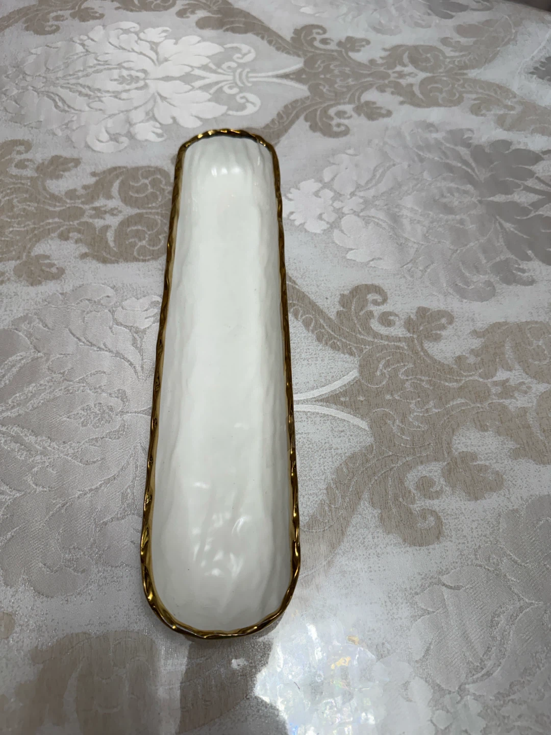 White oblong serving dish with gold trim