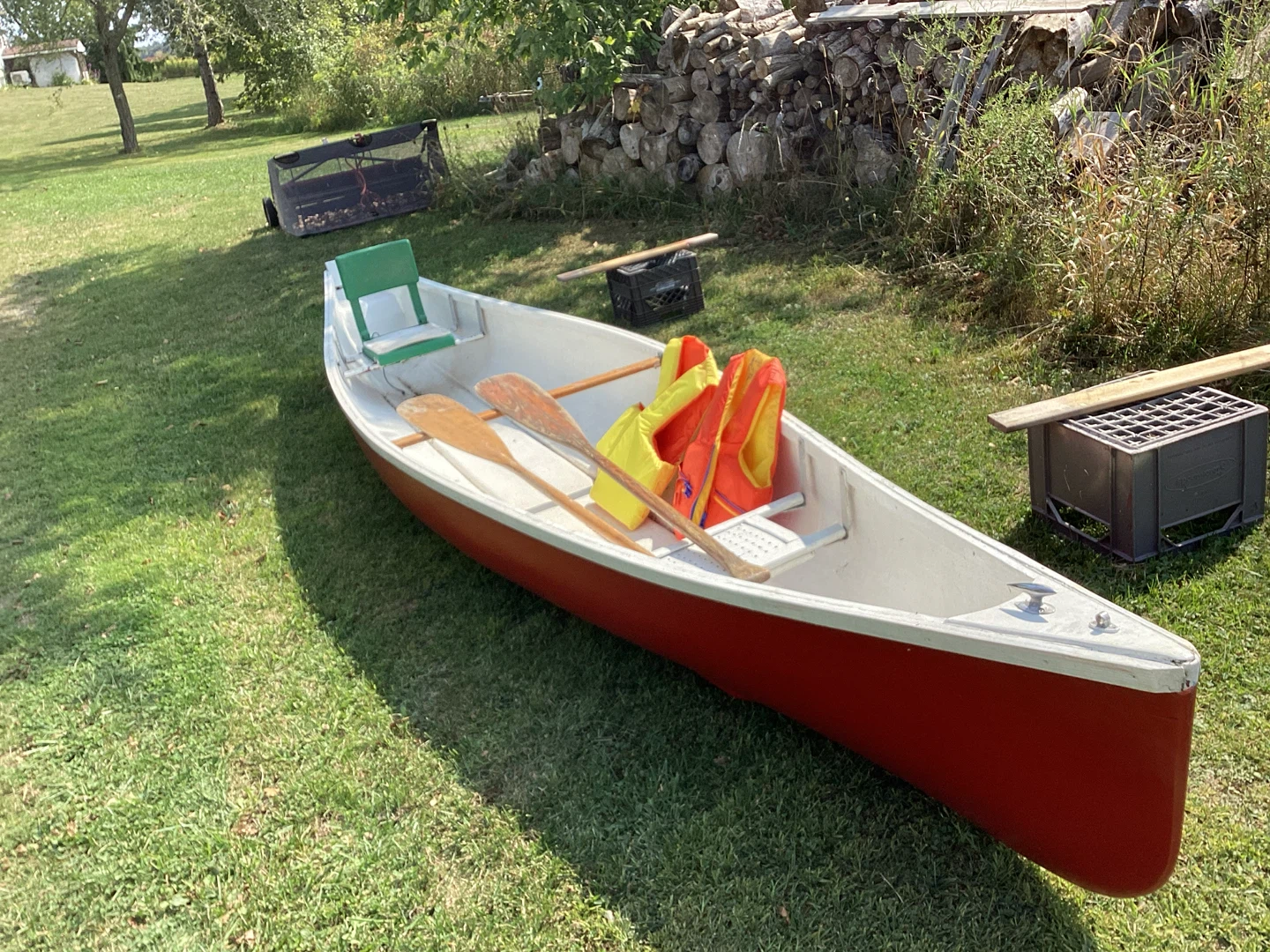Red Canoe with Paddles and Life Vests