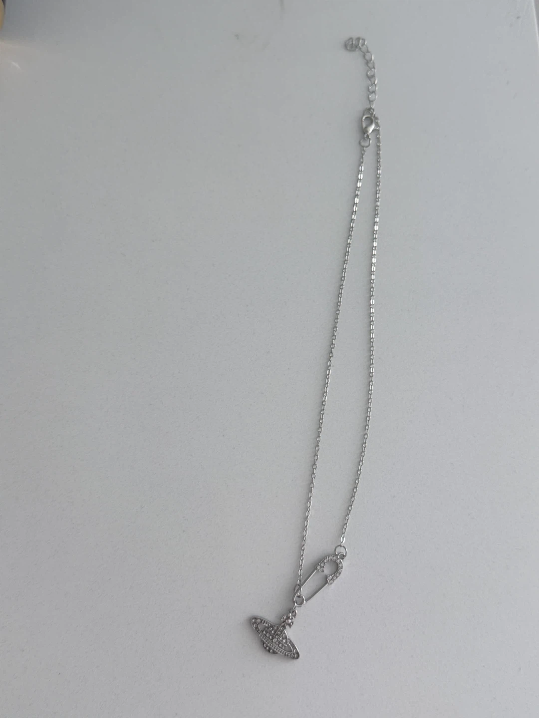 Silver planet pendant necklace with safety pin accent - photo 3