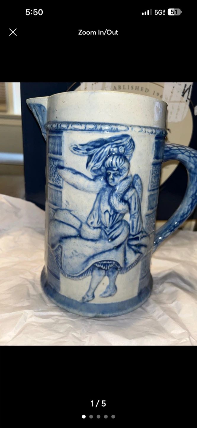 Embossed blue and white stoneware pitcher
