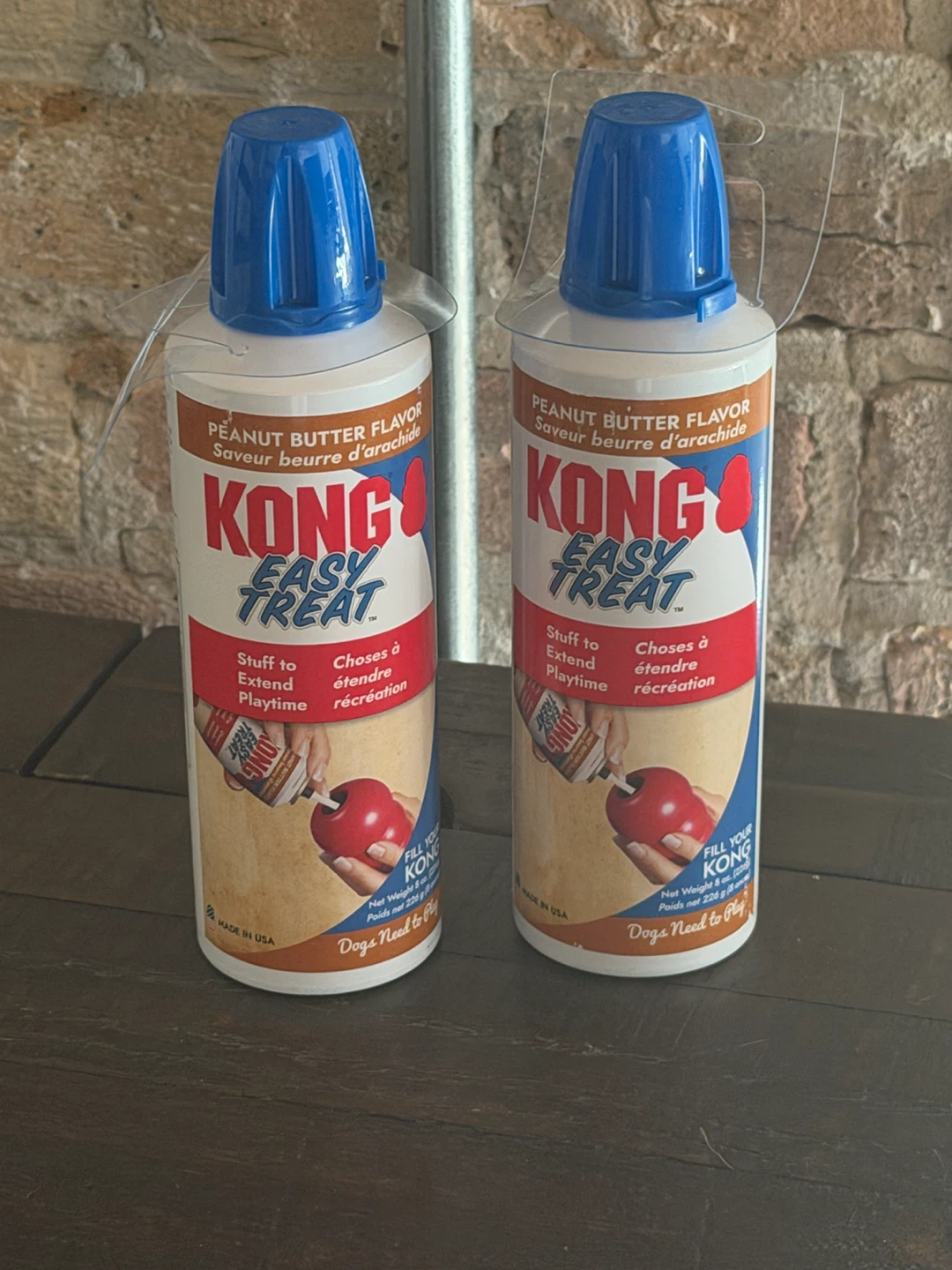 Two cans of Kong peanut butter flavor toy filler for dogs