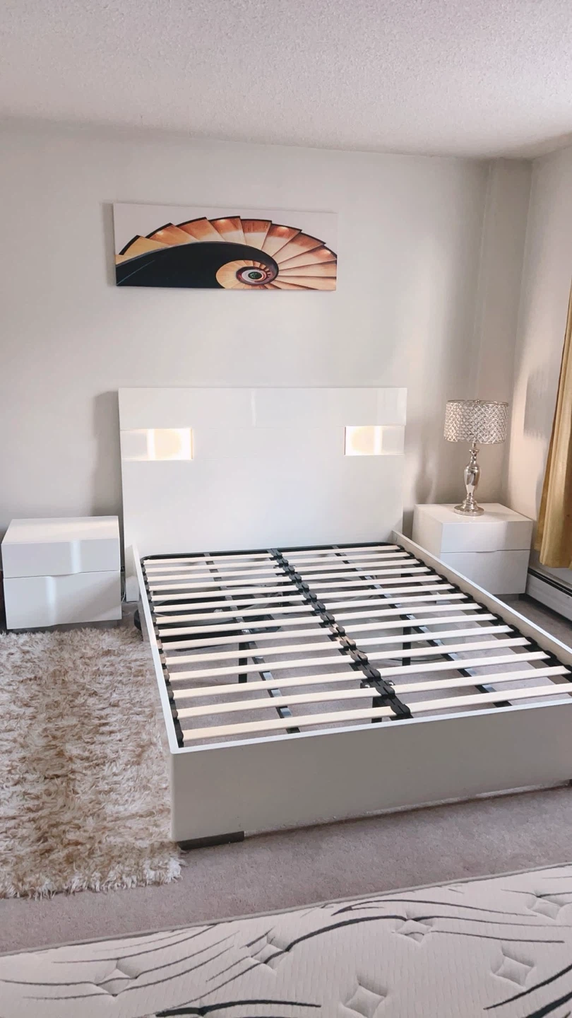 White queen size bed set with comfortable mattress.