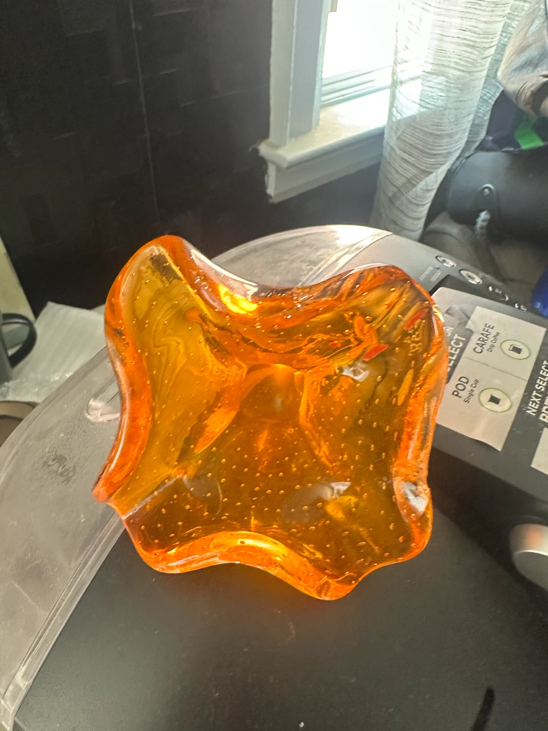Orange glass dish with bubbles
