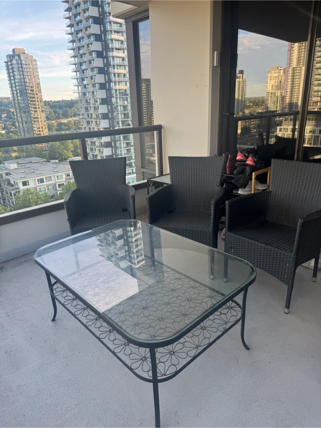 Wicker patio chairs and glass coffee table set