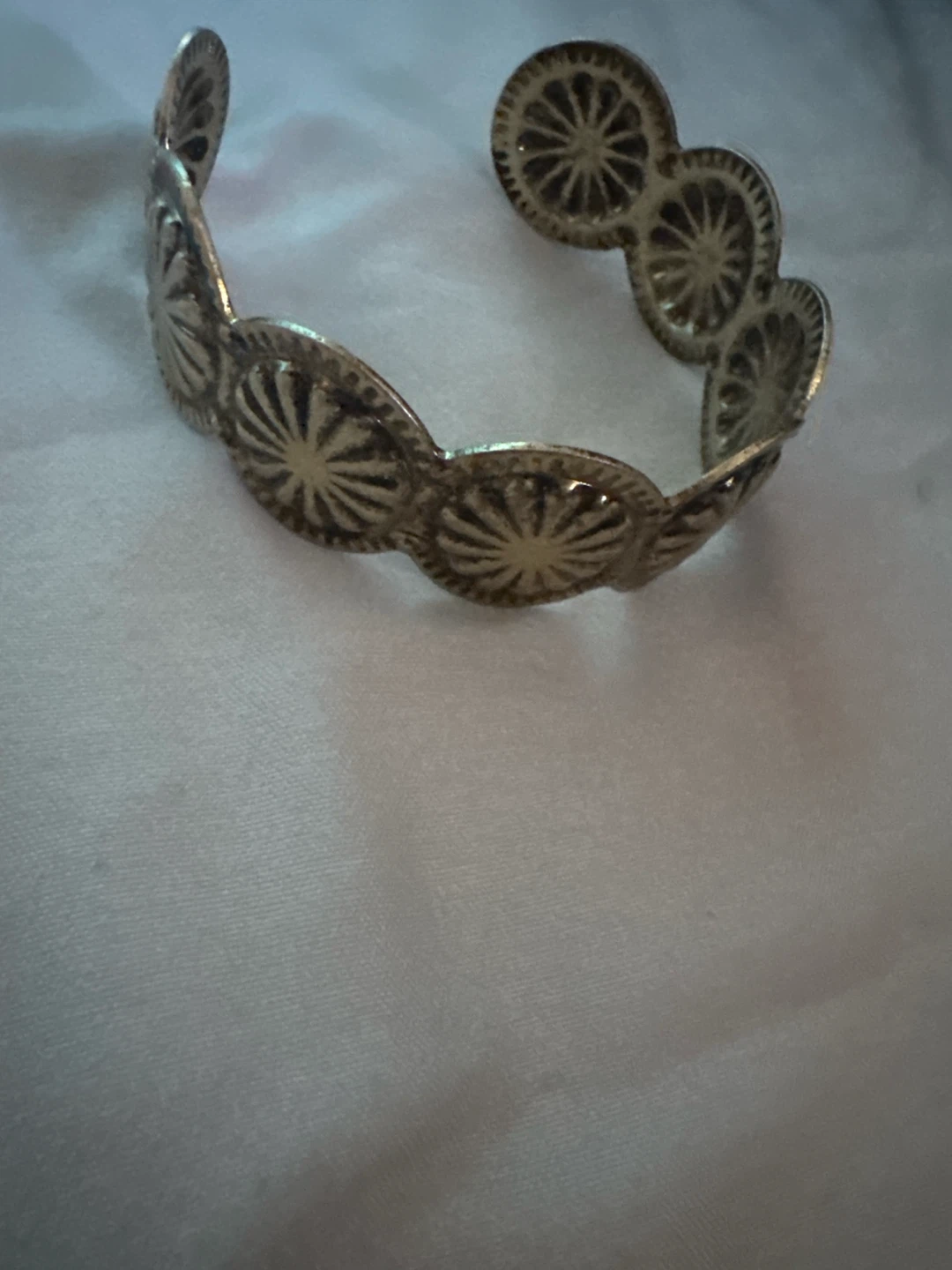 Silver-tone cuff bracelet with decorative sunbursts