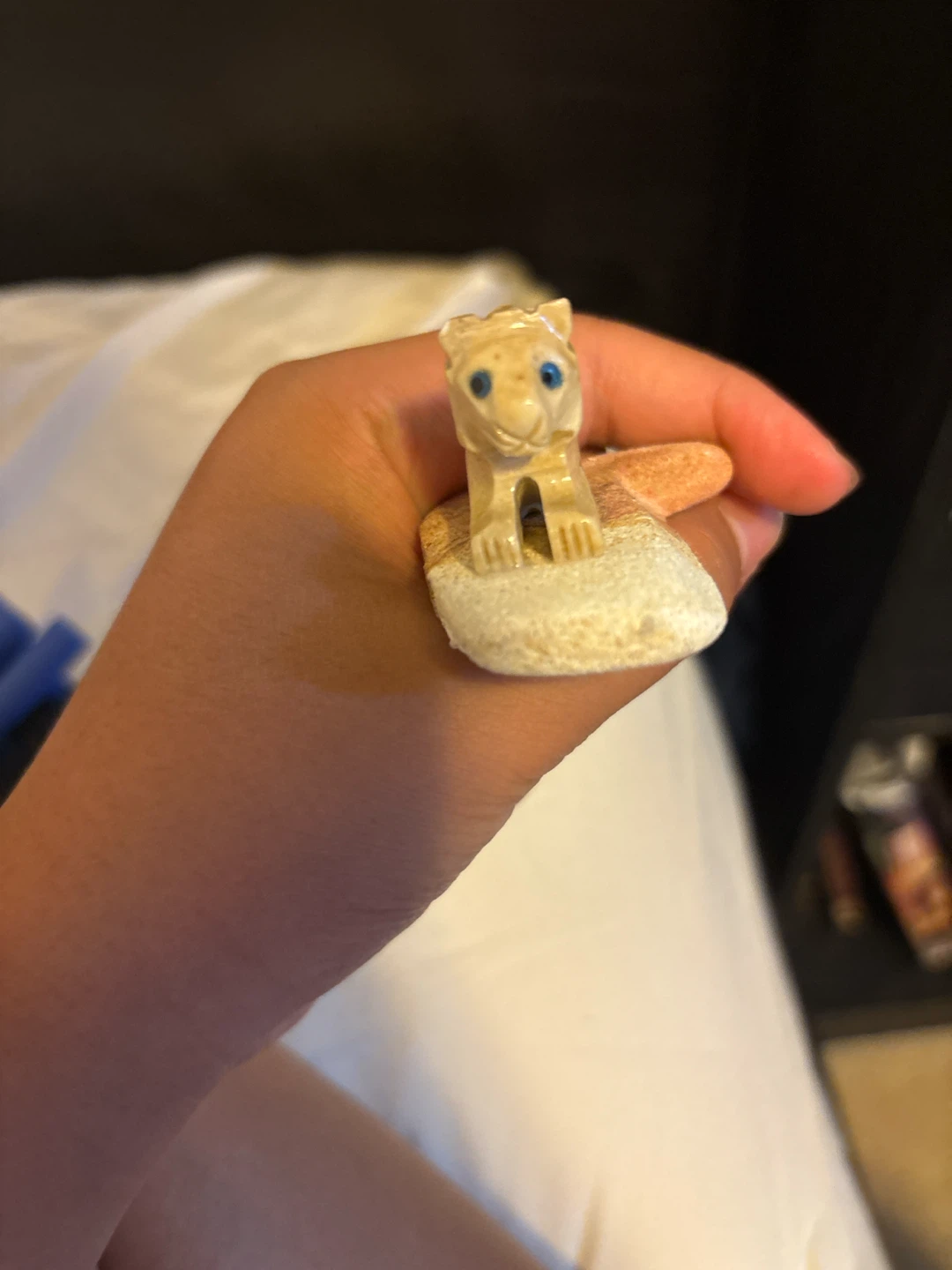 Small carved tiger figurine with blue eyes