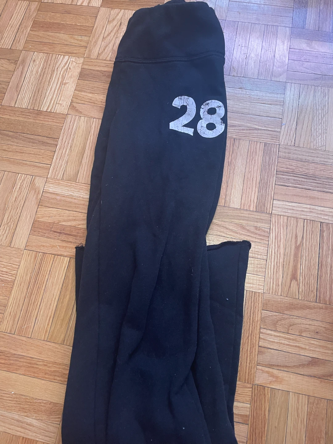 Black sweatpants with "28" graphic