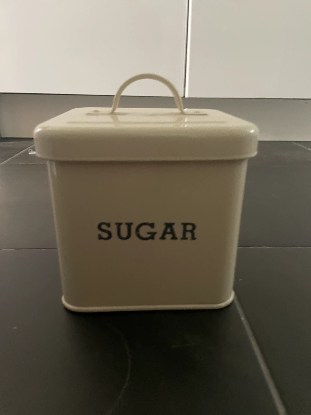 cream coloured tin storage container