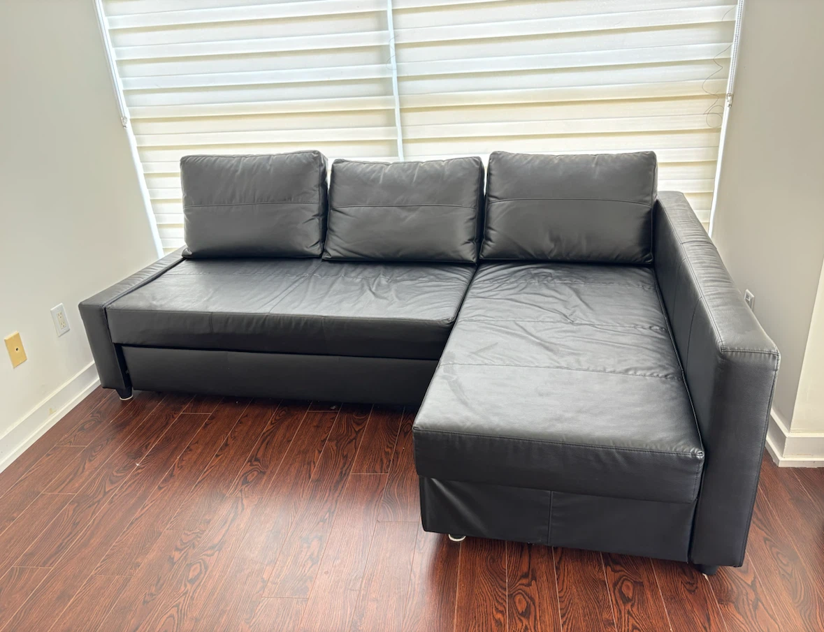 IKEA FRIHETEN black leather corner sofa with built-in storage
