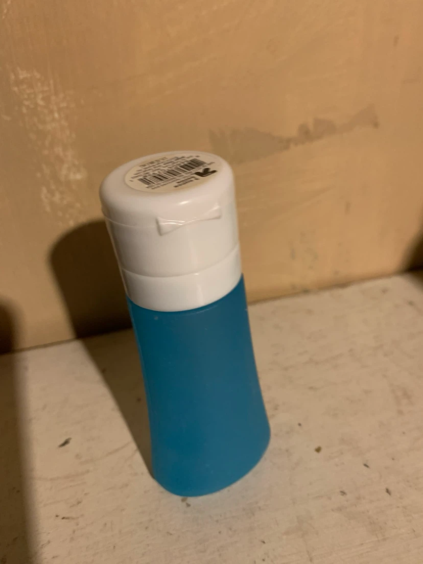 Blue Travel Bottle with White Flip Top Cap