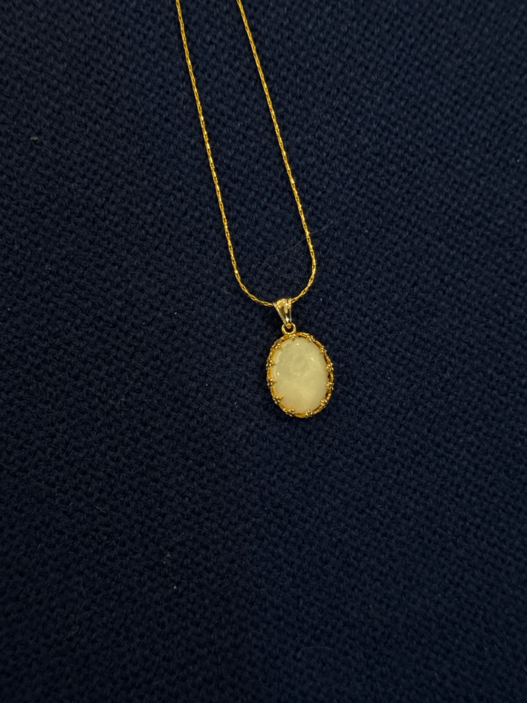 Gold tone pendant necklace with opal