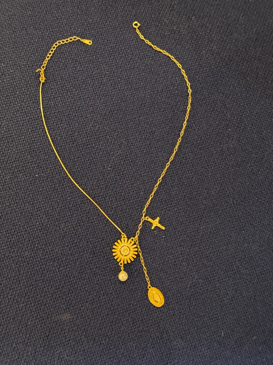 Gold Tone Necklace with Sun, Pearl, Oval, and Cross Charms