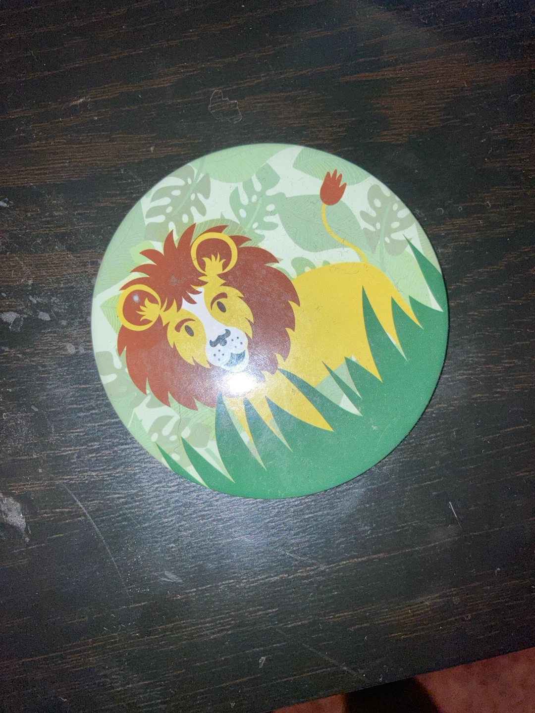 Round coaster with lion design