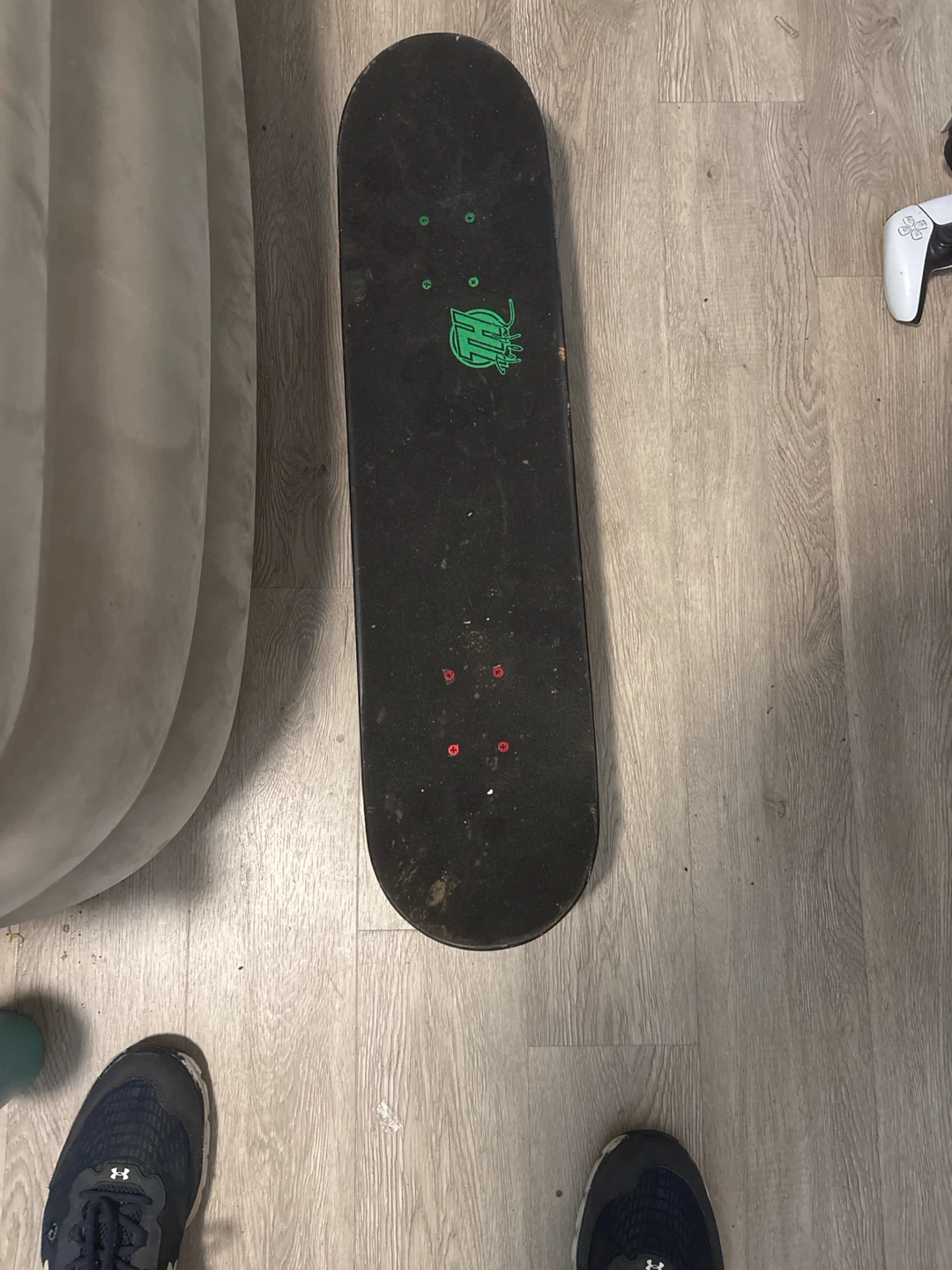 Black Skateboard with Green Logo