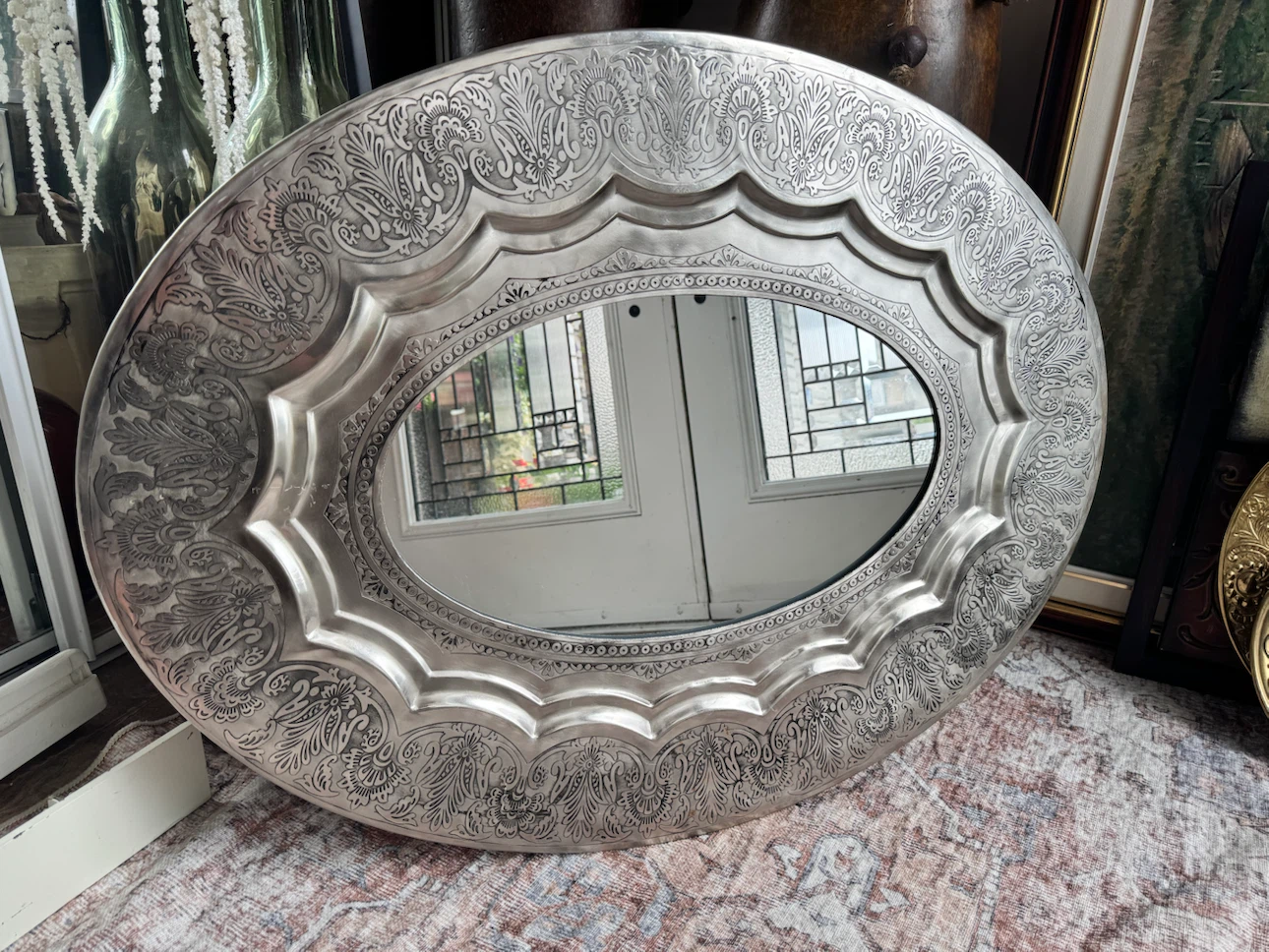 Oval Decorative Mirror with Ornate Silver-Tone Frame