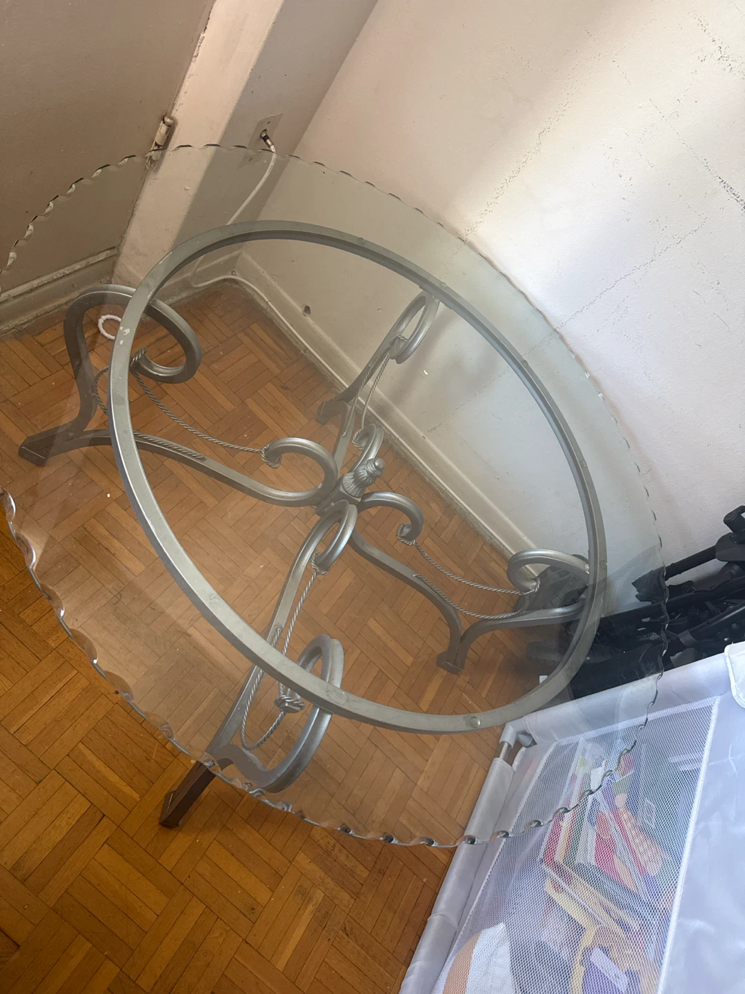 Glass top dining table with ornate metal base