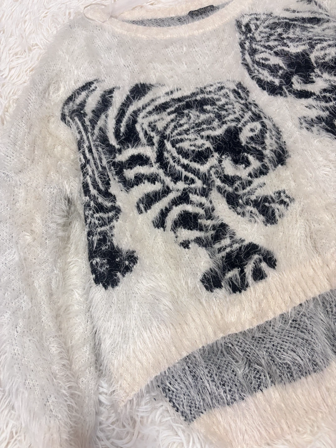 White fuzzy sweater with tiger graphic