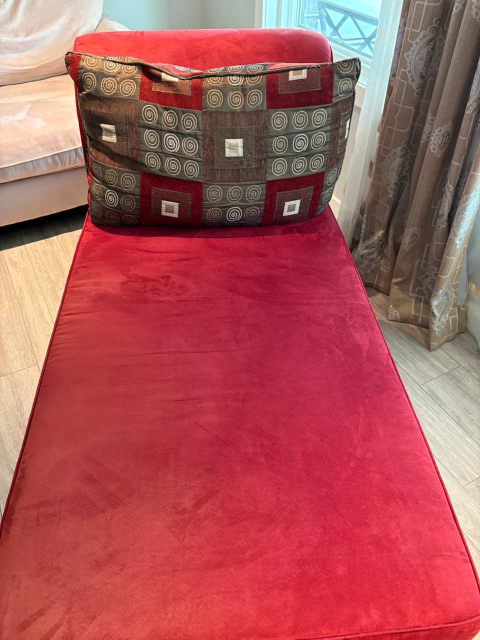 Red Chaise Lounge with Decorative Pillow