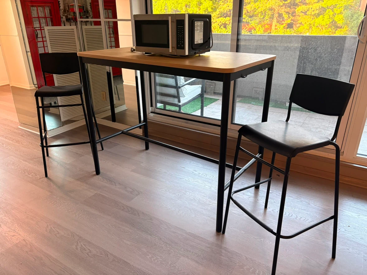 Bar table with five black stools