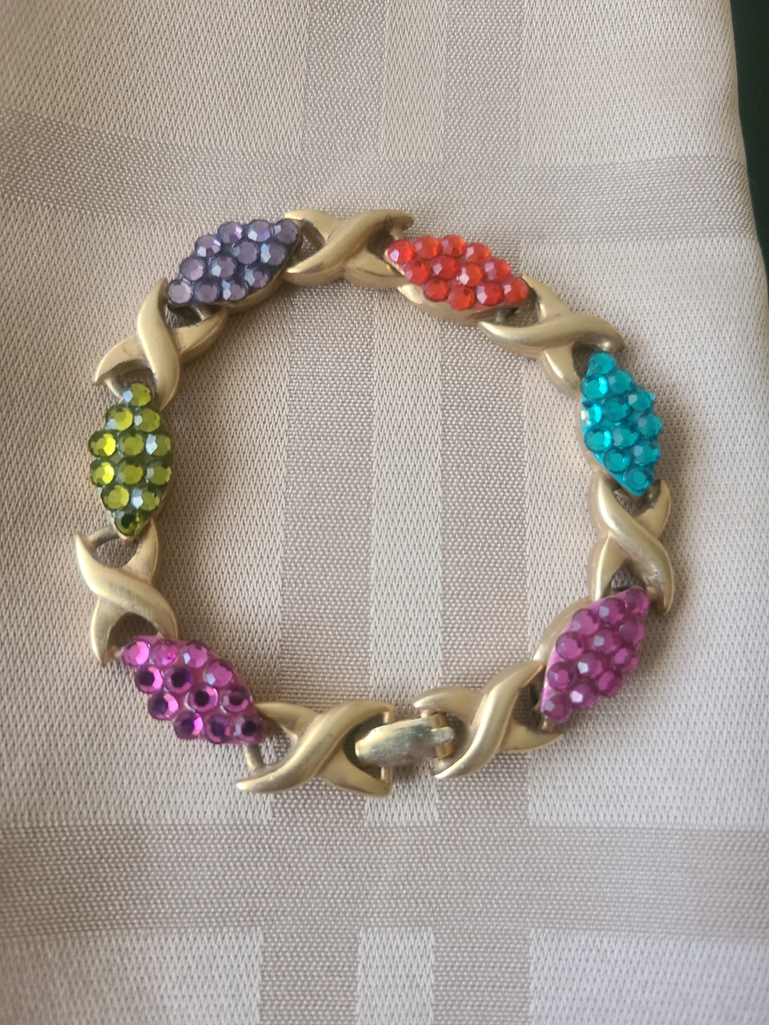 Gold tone XO link bracelet with colourful gems