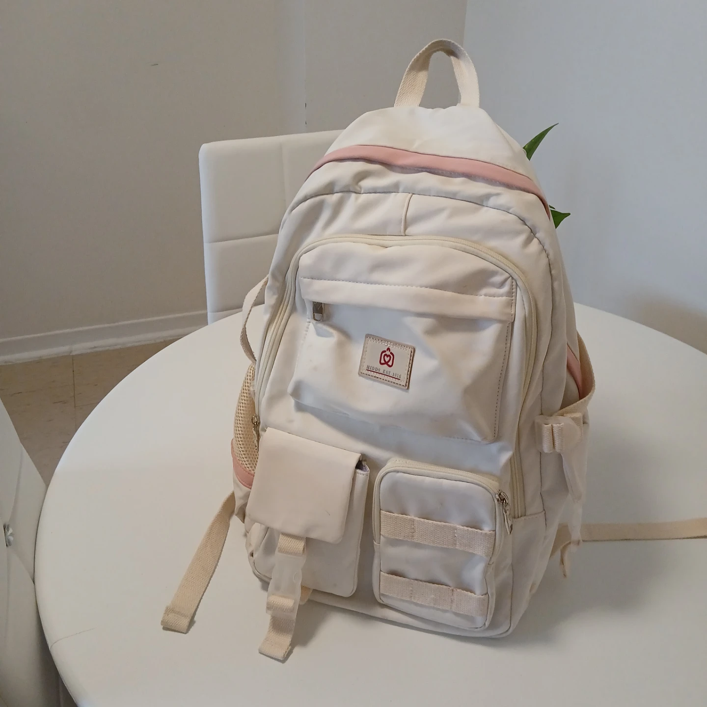Cream backpack with pink trim