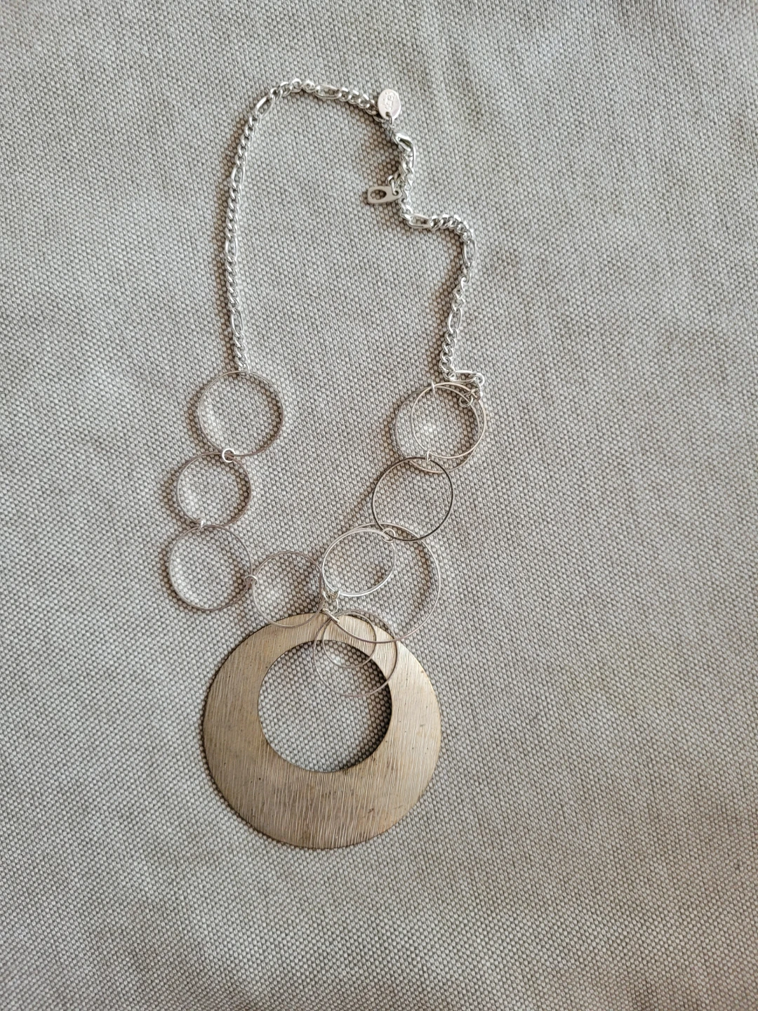 Silver tone statement necklace with large pendant