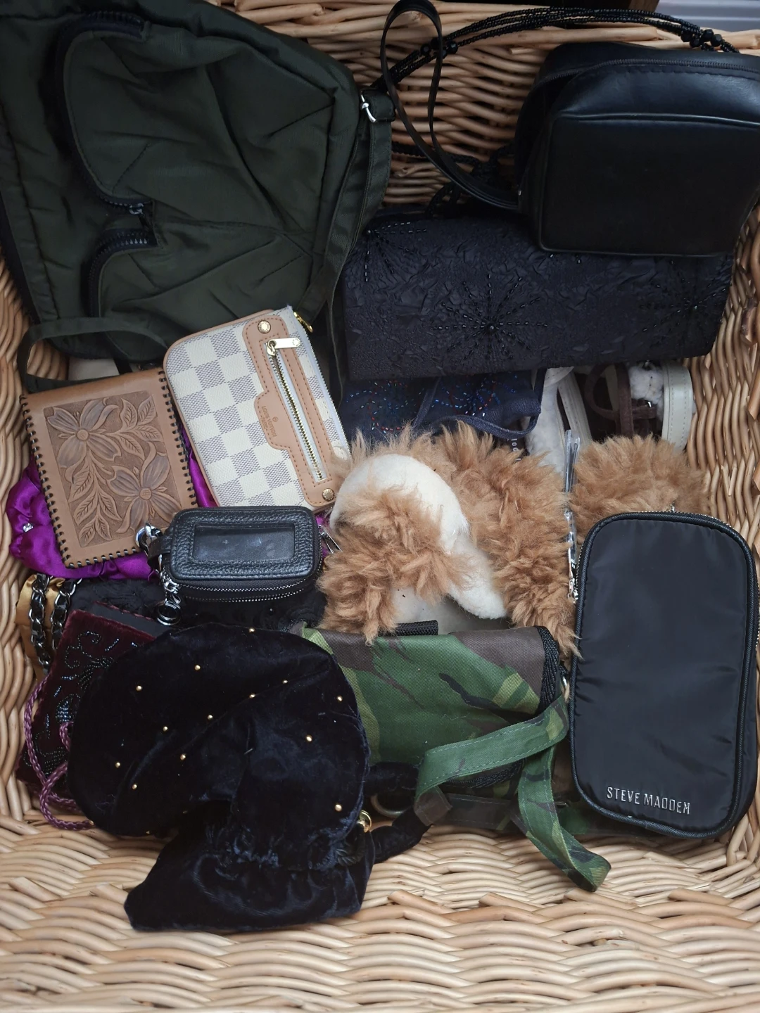 Wicker basket full of bags purses and wallets, 20 plus pieces
