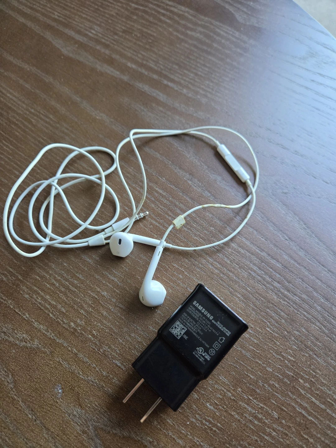 Samsung earphones and wall charger for A50 smartphone.