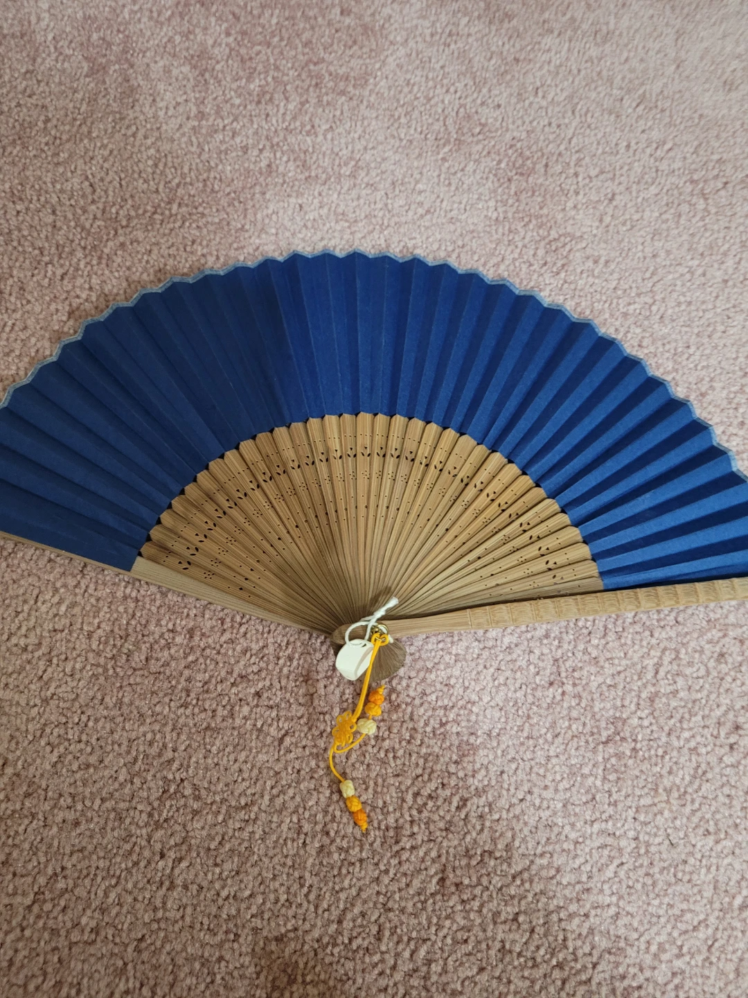 Blue folding fan with wooden handle