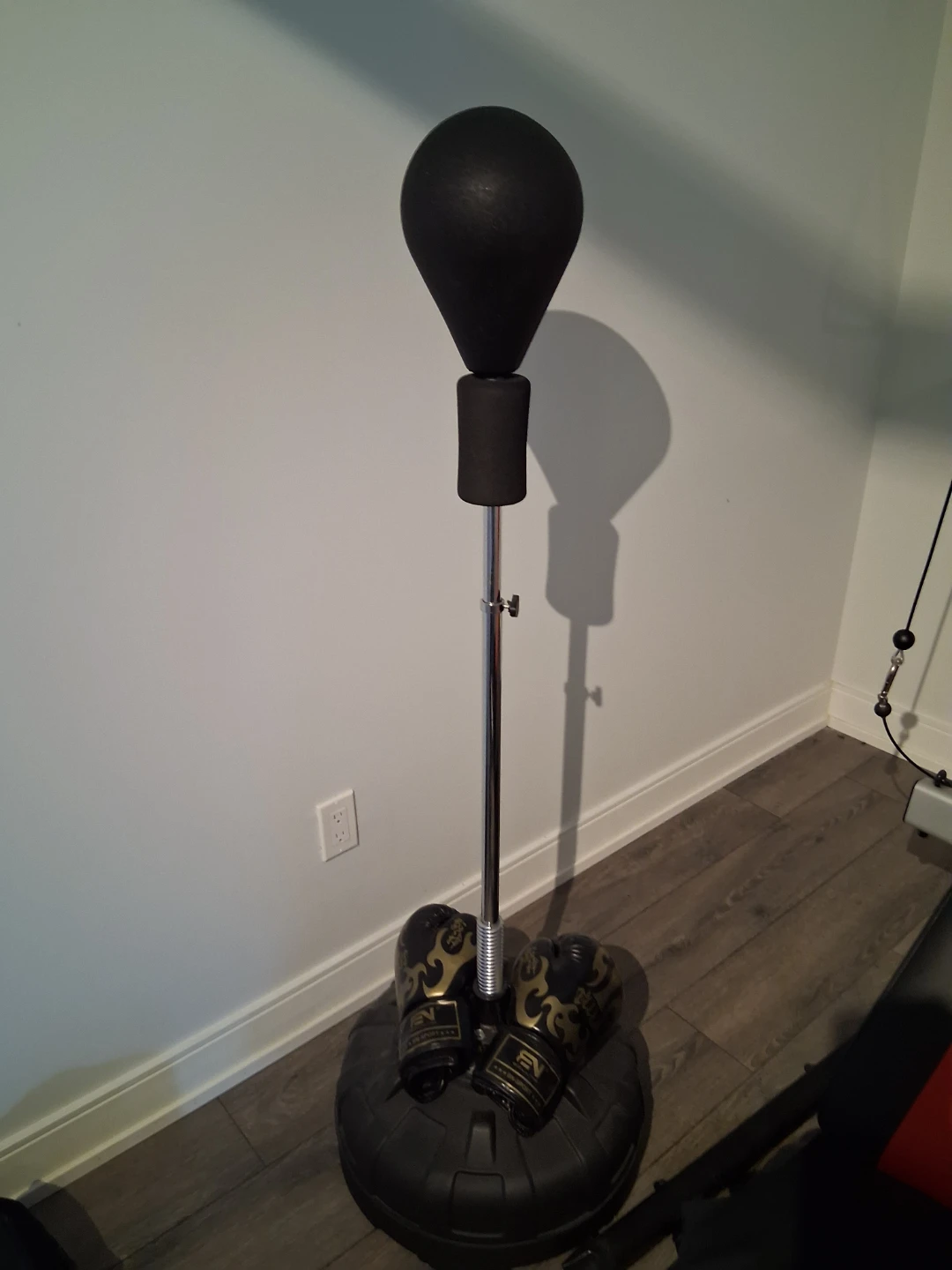 Adjustable punching bag stand with gloves