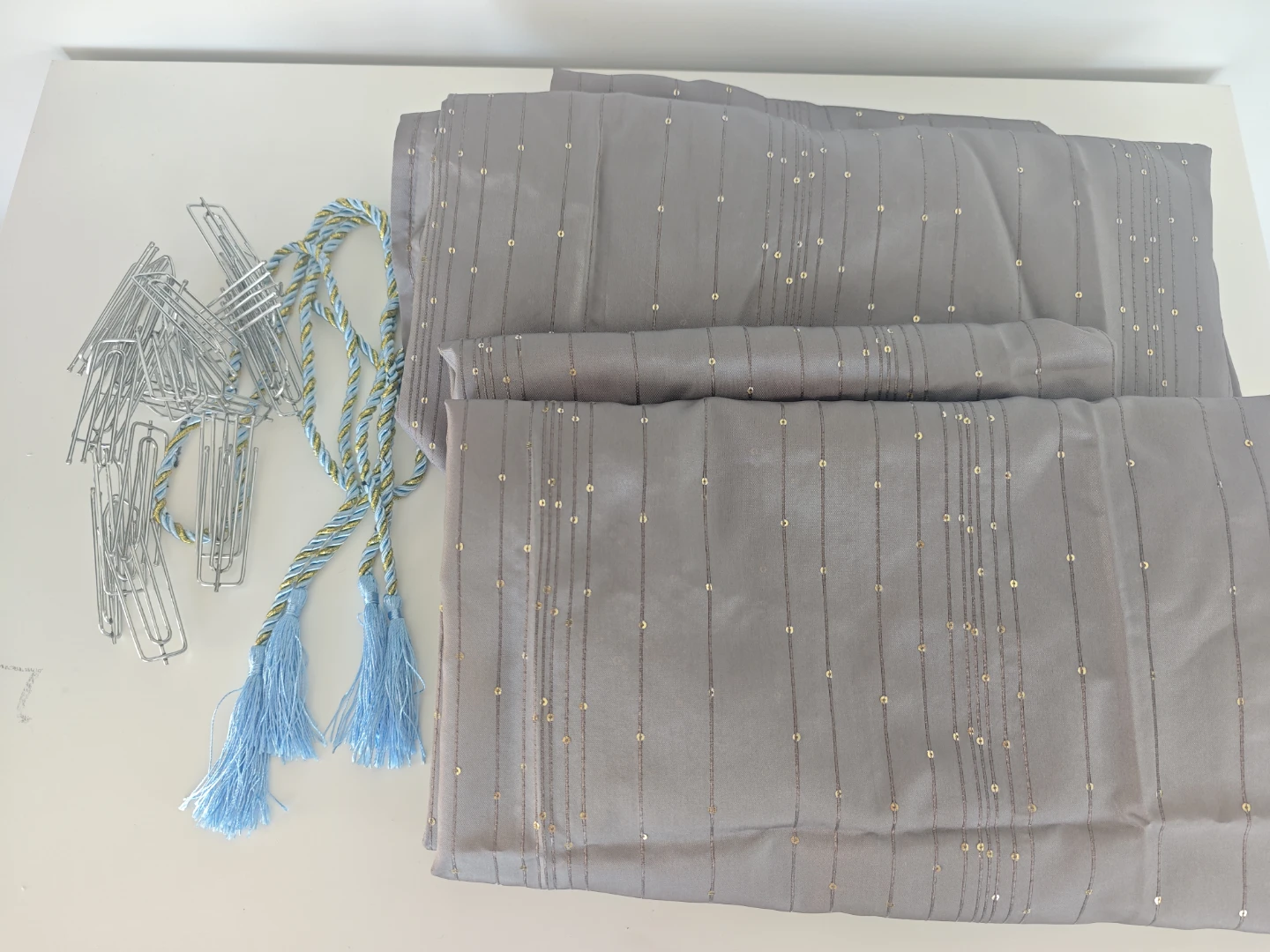 Grey sheer curtains with scattered glitter accents and tie-backs